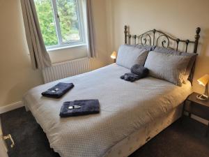Un dormitorio con una cama con dos artículos. en Lovely 2 bed appt with parking only 5 mins from M6 or Carlisle, en Carlisle