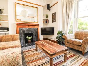 a living room with a fireplace and a table at Number 61 Skipton in Skipton