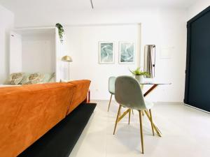 a living room with a couch and a table at RUBEN VELA - LOFT CLOSE to RUSSAFA (SOHO) in Valencia