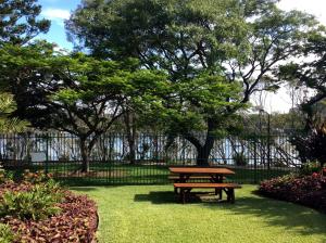 a picnic table in a park with trees and grass at Kirribilli Apartments in Brisbane