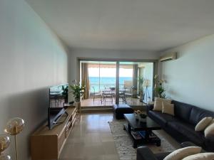 a living room with a couch and a view of the ocean at LE BAHIA in Nice