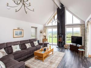 a living room with a couch and a tv at Morven View in Dunbeath