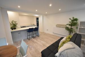 a living room with a couch and a table at Modern Apartment near City Centre and The Bay in Cardiff