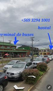 a parking lot with cars parked in front of a hospital at Hostal Capricho de Carlitos in Valdivia