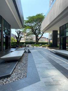 a courtyard of a building with a bench in the middle at The Base in pattaya in Pattaya Central