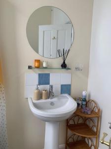 a bathroom with a white sink and a mirror at Cosy 2 bed flat in Baffins in Portsmouth