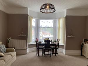 a dining room with a table and chairs and a window at Cosy 2 bed flat in Baffins in Portsmouth