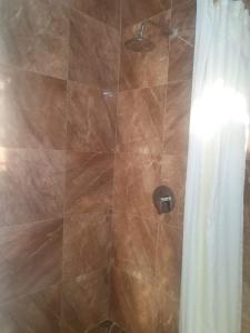 a bathroom with a shower with a shower curtain at Corinth Convinced in Gros Islet