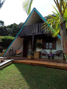 a house with a gambrel roof with a wooden deck at Casa de campo, charme e aconchego em cond. fechado in Atibaia