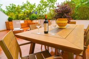 a table with a bottle of wine and two wine glasses at Charming Home in Sintra Village in Sintra