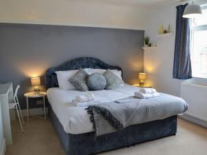 a bedroom with a bed with two pillows on it at Nalas Cottage in Skegness
