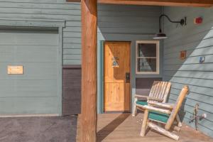 a rocking chair on the porch of a house at Ski Tip by Summit County Mountain Retreats in Keystone