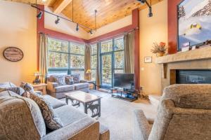 a living room with couches and a fireplace at Ski Tip by Summit County Mountain Retreats in Keystone