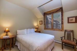 sypialnia z dużym białym łóżkiem i oknem w obiekcie Ski Tip by Summit County Mountain Retreats w mieście Keystone