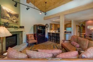 a living room with a couch and a fireplace at Ski Tip by Summit County Mountain Retreats in Keystone