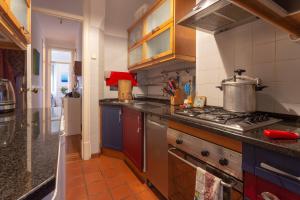 a kitchen with a stove with a pot on it at The Bleu Lisbon Flat in Lisbon