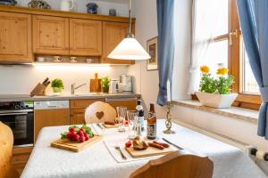 a kitchen with a table with fruits and vegetables on it at Landhaus Hubertus in Bad Tölz