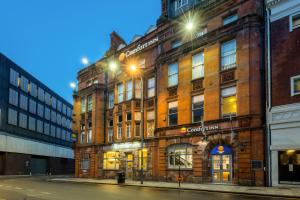 a large brick building on a street at night at Comfort Inn Birmingham in Birmingham