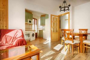 a living room with a table and a dining room at edificio CAPERAN 1 in Panticosa