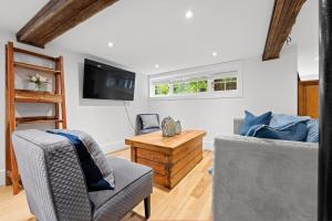 a living room with two chairs and a table at Waldemar Charming Burlington lower level Apartment in Burlington