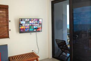 a television on a wall in a room at Casa Paraíso - 3rd Floor in San Juan del Sur