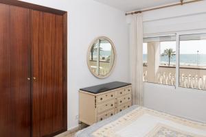 a bedroom with a dresser and a mirror at Lider, 2-G in Cullera +22 photos