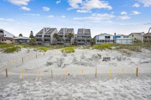 a sand sculpture on the beach with houses in the background at Pelican Pointe 2C in Clearwater Beach