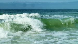 a wave in the ocean on a sunny day at Pelican Pointe 2C in Clearwater Beach
