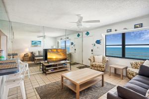 a living room with a view of the ocean at Sunset Chateau 409 in St. Pete Beach