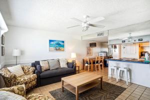 a living room with a couch and a table at Sunset Chateau 409 in St Pete Beach