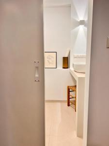a white bathroom with a sink and a counter at ADI BOUTIQUE HOUSE in Thessaloniki
