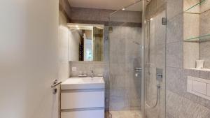 a bathroom with a shower and a sink and a mirror at Abitaziun Bellaval 1A - Celerina in Celerina +31 photos