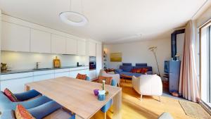 a kitchen and living room with a table and chairs at Abitaziun Bellaval 1A - Celerina in Celerina