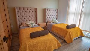 Postel nebo postele na pokoji v ubytování Shanarani Apartament