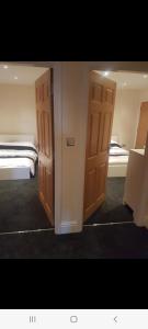 two open doors in a room with two beds at Spacious fully furnished 2 bed appartment next to BAE, in Barrow in Furness