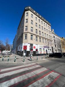 a large building on a city street with a crosswalk at Turquoise inspired deluxe centrally located in Vienna