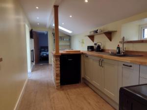 a kitchen with a sink and a counter top at The Old Dairy in Dunball