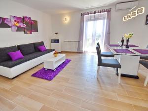 a living room with a couch and a table at Apartments Garden Residence in Opatija