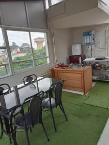 a kitchen with a table and chairs in a room at The Jugglers Rest in Mysore