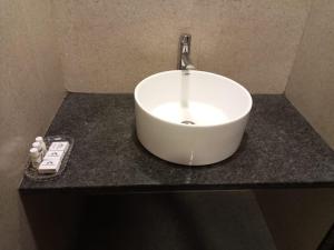 a white sink sitting on top of a counter at Khushi Riverside Resort & Spa in Mahabaleshwar