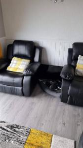 a living room with two chairs and a couch at Beautiful 2-Bed Chalet in Aberystwyth in Aberystwyth