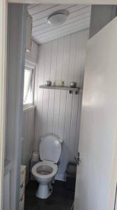 a small bathroom with a toilet and a window at Beautiful 2-Bed Chalet in Aberystwyth in Aberystwyth