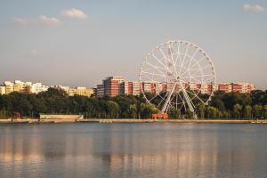 a ferris wheel sitting in the middle of a lake at SUNSHINE - New & Quiet 1BR Apt, Business area, close to Airport, Highway A3, Subway in Bucharest