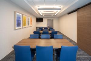 a conference room with a long table and blue chairs at Holiday Inn Express Hotel & Suites Grand Junction by IHG in Grand Junction +55 photos
