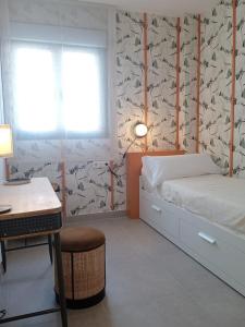 1 dormitorio con cama, escritorio y escritorio en LANUZA - Apartamentos Down Town Málaga Centro en Málaga