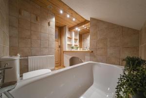 a large bath tub in a bathroom with a sink at Apartamenty u Giewonta in Zakopane