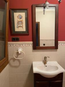 a bathroom with a sink and a mirror at La Casa De Marta in Madrigal de la Vera