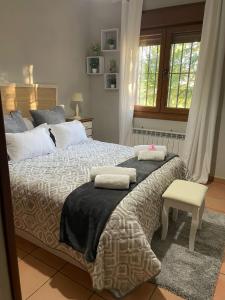 a bedroom with a large bed with two pillows on it at La Casa De Marta in Madrigal de la Vera
