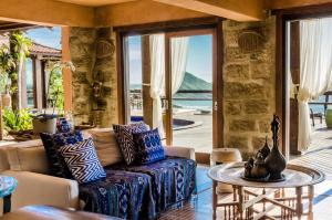 a living room with a couch and a table at Solar Mirador Exclusive Resort e SPA in Praia do Rosa