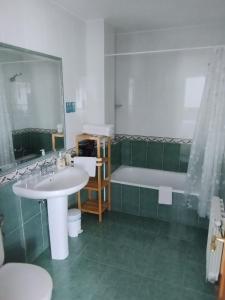 a bathroom with a sink and a bath tub at Alto Santiago in San Vicente de la Barquera